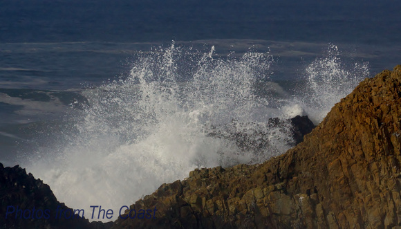 Splash Behind Large Coastal Rocks